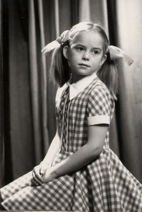 María as a child in a checked dress with ribbons in her hair, Iceland, 1960s