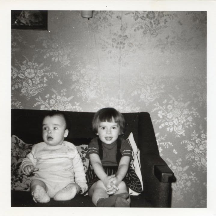 María and a sibling as toddlers on a sofa, Iceland, 1960s